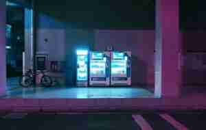 a couple of vending machines sitting on the side of a road